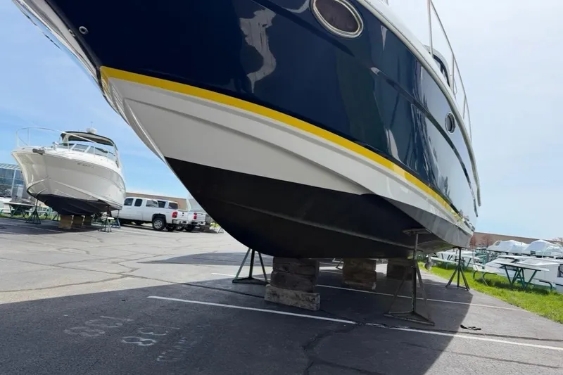 Slide: The Image of 2007 Regal Commodore 3760 IO boat on stands in a marina parking lot. - 53