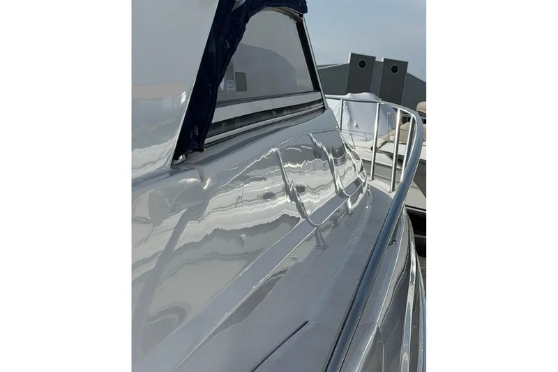 Slide: The Image of 2007 Regal Commodore 3760 IO yacht, side view with sleek design and railing. - 57