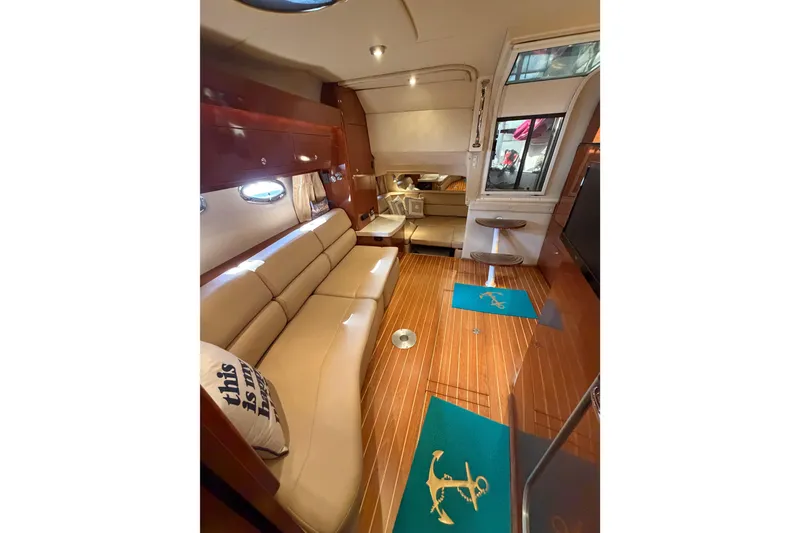 Slide: The Image of Luxurious interior of 2007 Regal Commodore 3760 IO yacht with elegant seating and wooden flooring. - 39