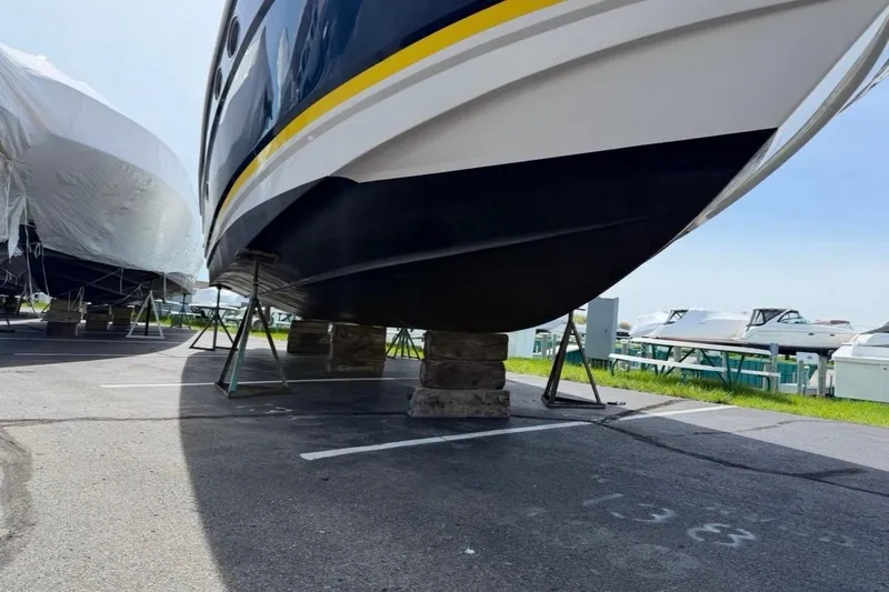 Slide: The Image of 2007 Regal Commodore 3760 IO boat on stands in a marina parking lot. - 52