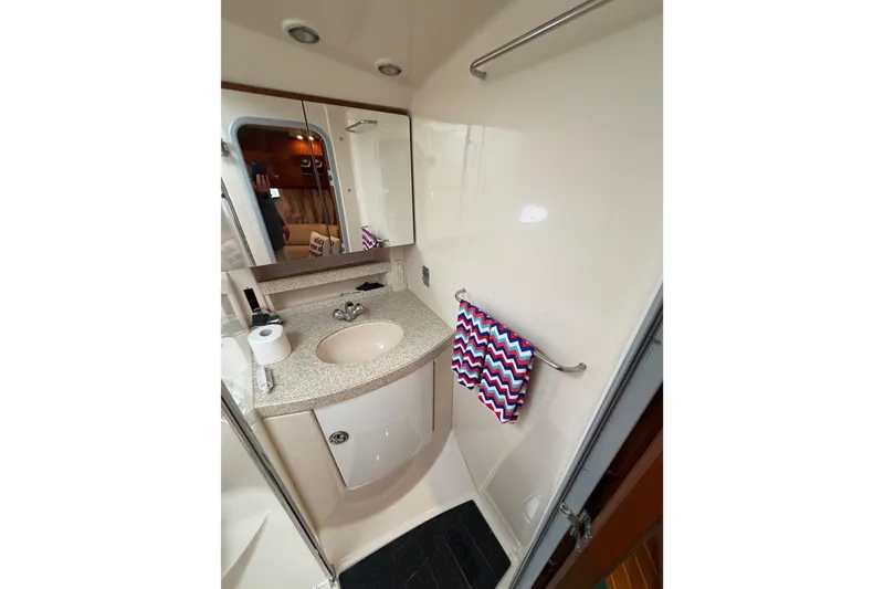Slide: The Image of Bathroom interior of 2007 Regal Commodore 3760 IO yacht with sink and mirror. - 36