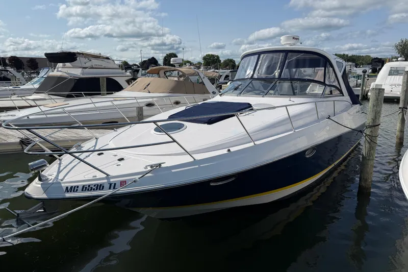 Slide: The Image of 2007 Regal Commodore 3760 IO yacht docked at marina under cloudy sky. - 2