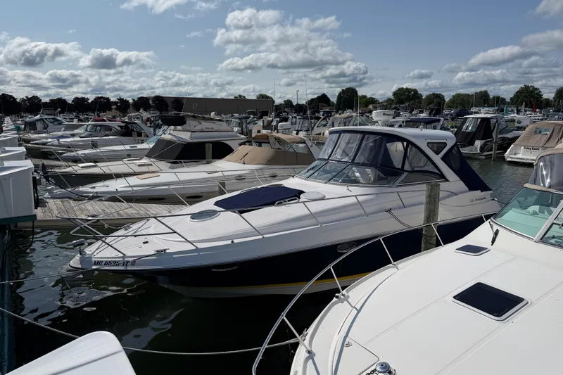 Slide: The Image of 2007 Regal Commodore 3760 IO docked among other boats at a marina. - 3