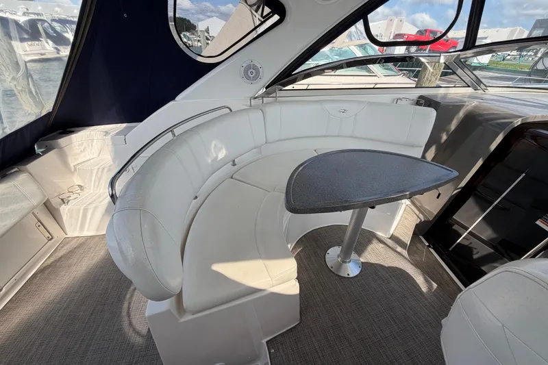 Slide: The Image of 2007 Regal Commodore 3760 IO boat interior with curved seating and table. - 9
