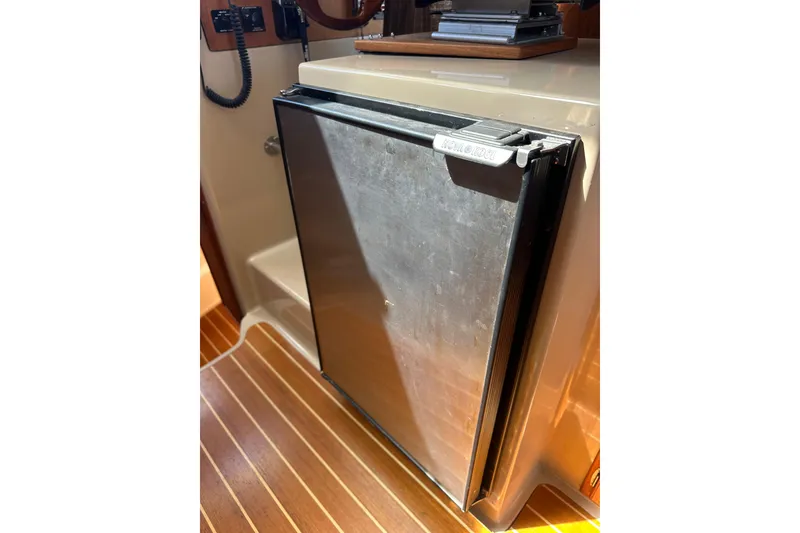Slide: The Image of Compact refrigerator inside 2011 Ranger Tugs R-29 boat, featuring sleek design and wood flooring. - 20