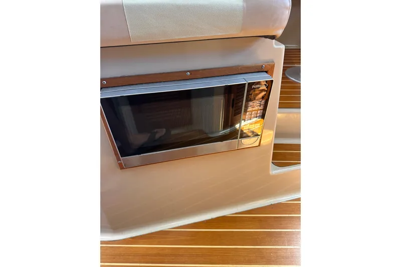 Slide: The Image of Microwave in 2011 Ranger Tugs R-29 boat interior with wooden flooring. - 24