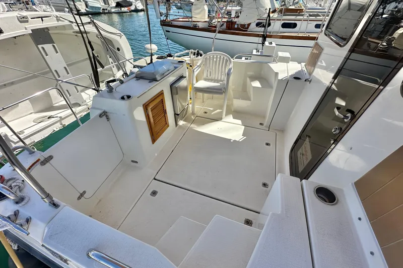 Slide: The Image of 2011 Ranger Tugs R-29 boat deck with seating, docked at marina. - 13
