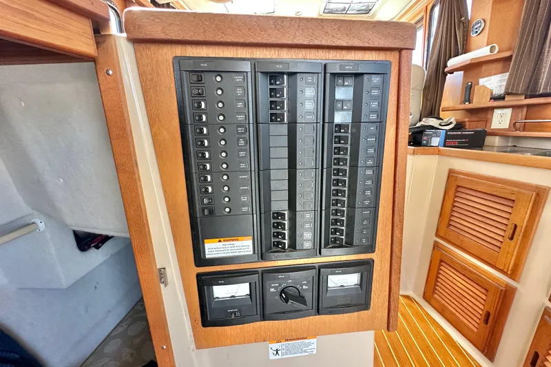 Slide: The Image of Electrical panel inside a 2011 Ranger Tugs R-29 boat, featuring switches and meters. - 15