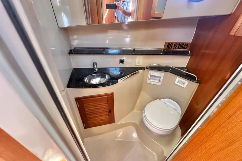 Slide: The Image of Compact bathroom in 2011 Ranger Tugs R-29 with sink, toilet, and mirror. - 19