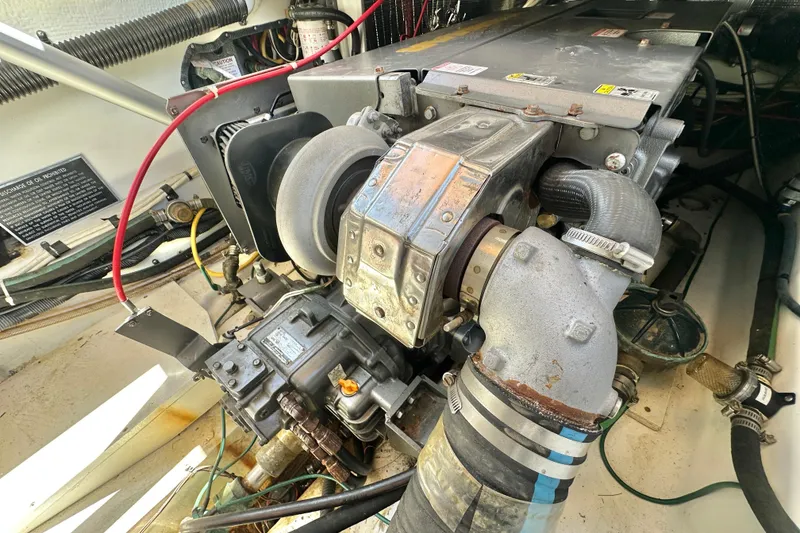 Slide: The Image of Engine compartment of a 2011 Ranger Tugs R-29, showcasing mechanical components and hoses. - 29