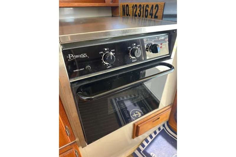 Slide: The Image of Princess oven in 2011 Ranger Tugs R-29 boat kitchen, featuring control knobs and oven light. - 26