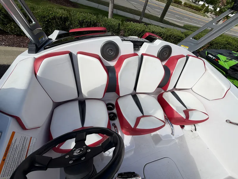 Slide: The Image of Interior view of a 2017 Scarab 165 with white and red seats and a black steering wheel. - 13