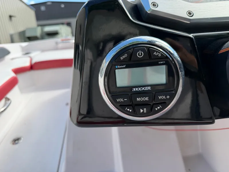 Slide: The Image of Close-up of a boat audio system with Kicker control unit, surrounded by white and red seating. - 12