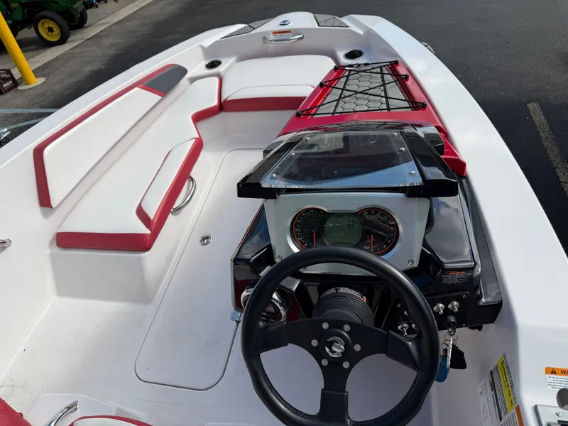 Slide: The Image of The image shows the cockpit of a 2017 Scarab 165 boat with red and white seating. - 8