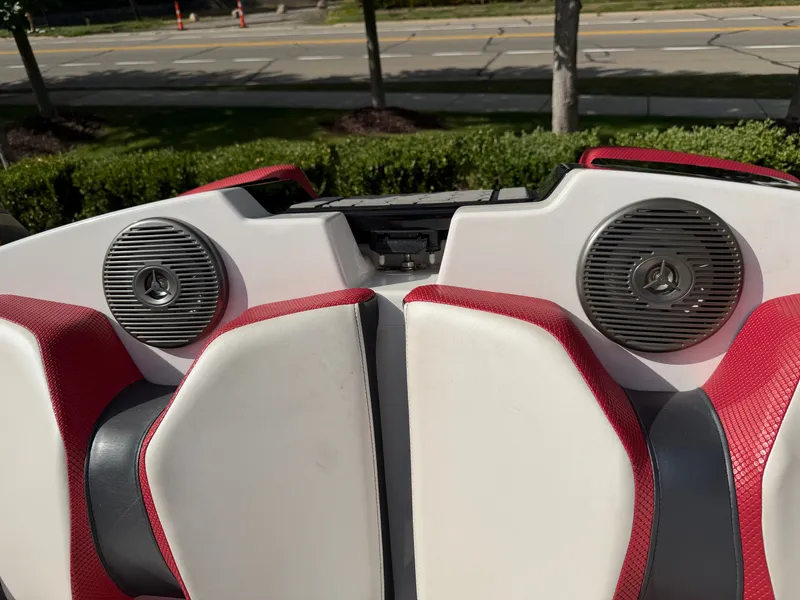 Slide: The Image of Rear view of a boat with red and white seats and speakers. - 20