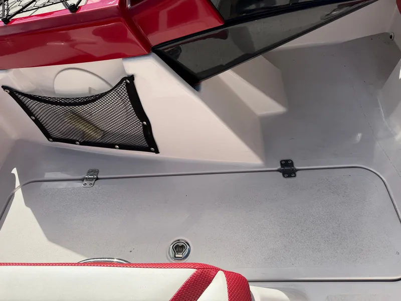 Slide: The Image of The image shows the interior of a 2017 Scarab 165 boat with red accents. - 18