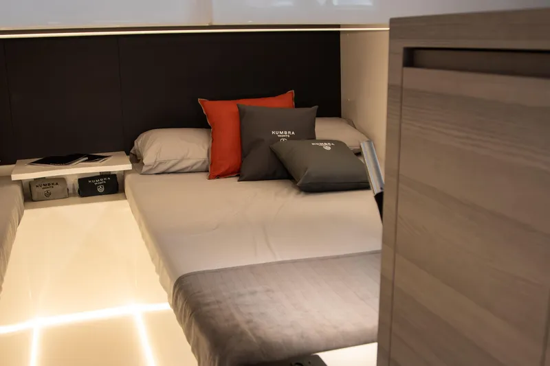Slide: The Image of Luxurious Kumbra 43 yacht interior, 2026 model, featuring a modern bedroom with stylish bedding. - 18