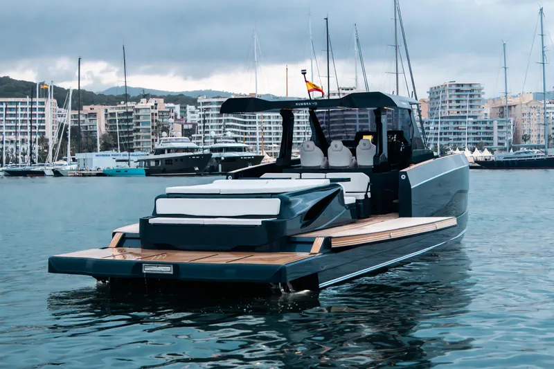 Slide: The Image of Luxury Kumbra 43 yacht in marina, 2026 model, sleek design, cityscape background. - 12