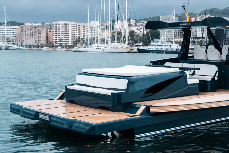 Slide: The Image of Luxury Kumbra 43 yacht, 2026 model, docked in a marina with cityscape background. - 14