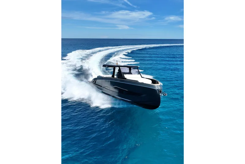 Slide: The Image of Sleek 2026 Kumbra 43 yacht cruising on vibrant blue ocean waters. - 4