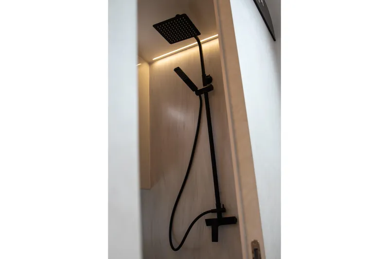 Slide: The Image of Modern shower with black fixtures in a Kumbra 43, 2026 model. - 19