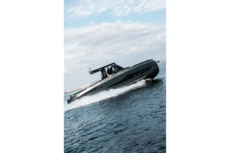 Slide: The Image of 2026 Kumbra 43 boat cruising on open water under a cloudy sky. - 11