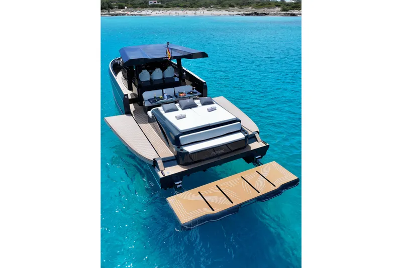 Slide: The Image of Luxury Kumbra 43 yacht, 2026 model, anchored in clear turquoise waters. - 7