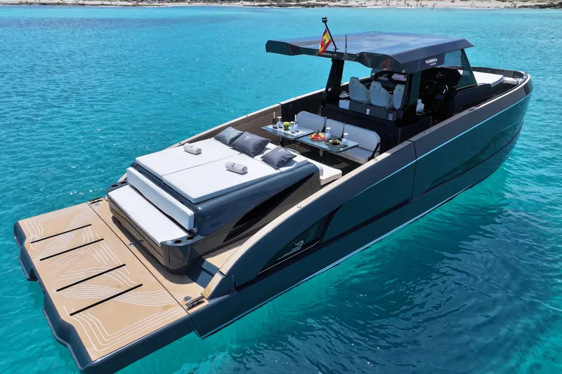 Slide: The Image of Luxury Kumbra 43 yacht, 2026 model, anchored in clear turquoise waters. - 9