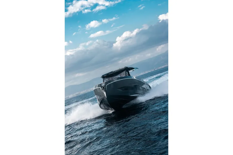 Slide: The Image of Sleek 2026 Kumbra 43 boat cruising on open water under a cloudy sky. - 10