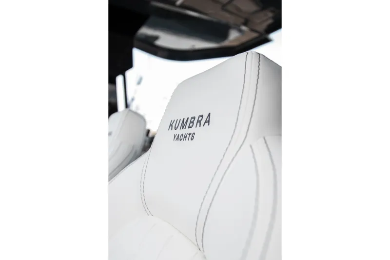 Slide: The Image of Luxurious white leather seat with "Kumbra Yachts" branding, model 43, year 2026. - 16