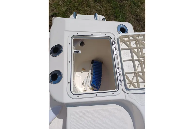 Slide: The Image of Open storage compartment on 2006 Key West 176 Sportsman CC boat with coiled blue hose. - 10