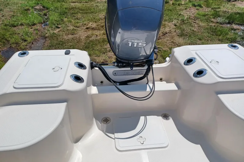 Slide: The Image of 2006 Key West 176 Sportsman CC boat with Yamaha 115 engine, featuring rod holders and storage compartments. - 3