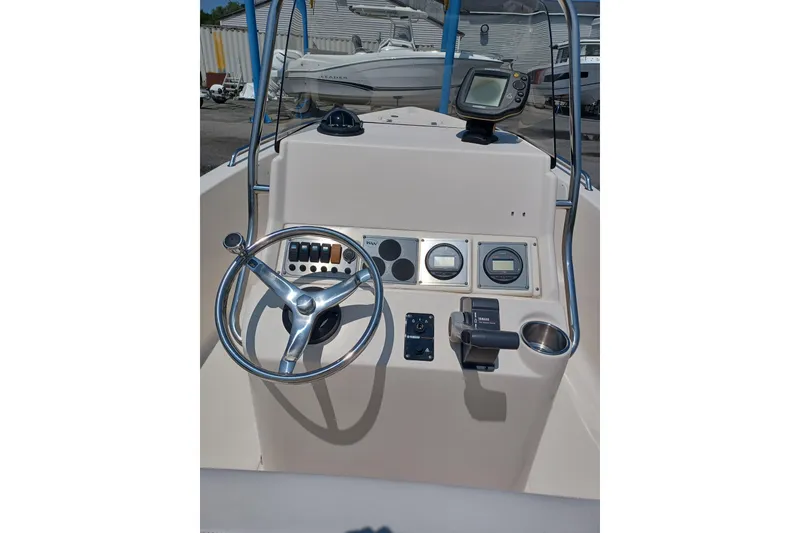 Slide: The Image of 2006 Key West 176 Sportsman CC boat console with steering wheel and gauges. - 4
