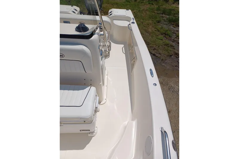 Slide: The Image of 2006 Key West 176 Sportsman CC boat interior with white seating and clean deck. - 9