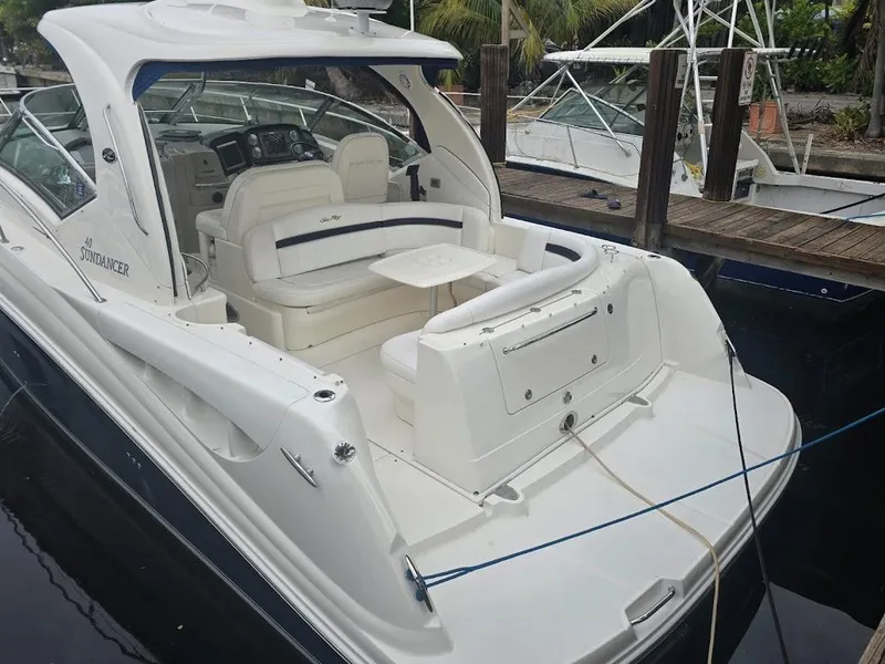 Slide: The Image of 2008 Sea Ray 40 Sundancer yacht docked, featuring spacious seating and sleek design. - 6