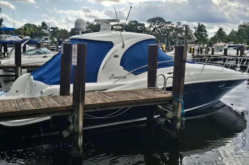 Slide: The Image of 2008 Sea Ray 40 Sundancer yacht docked at marina with blue covers. - 2