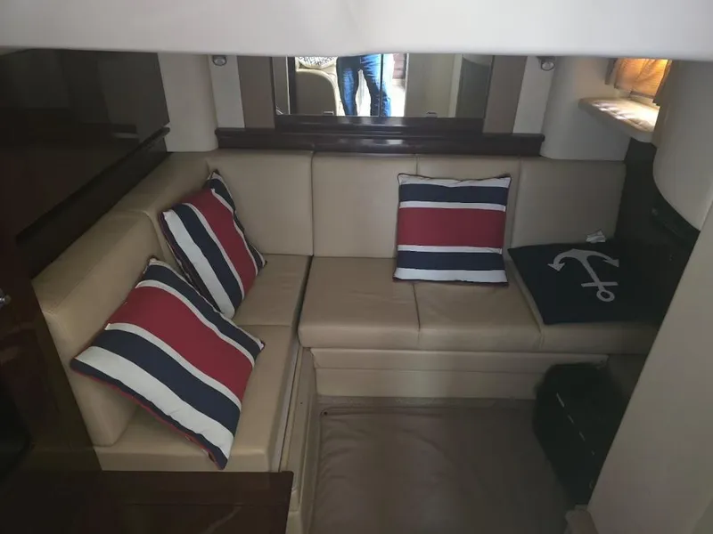 Slide: The Image of Interior of 2008 Sea Ray 40 Sundancer with beige seating and nautical-themed pillows. - 24