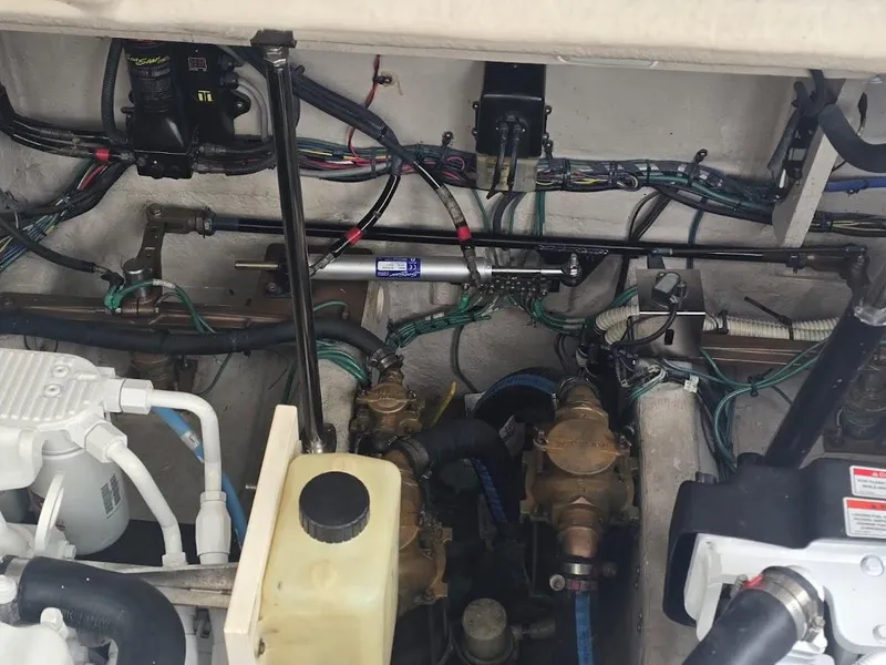 Slide: The Image of Engine compartment of a 2008 Sea Ray 40 Sundancer, showcasing mechanical components and wiring. - 27