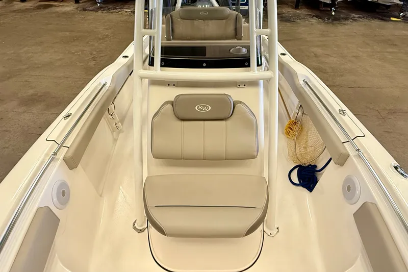 Slide: The Image of The image shows the cockpit of a 2023 Key West 219 FS boat with beige seating. - 14