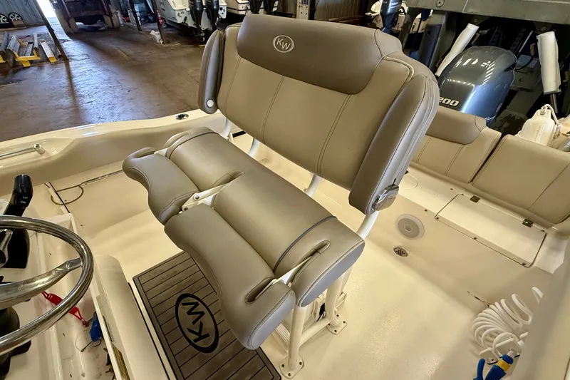 Slide: The Image of The image shows the beige upholstery of the seats on a Key West 219 FS boat. - 25