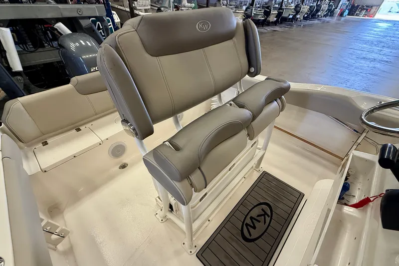 Slide: The Image of The image shows the seating of a Key West 219 FS boat in a showroom. - 24