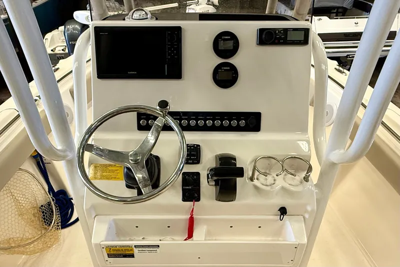 Slide: The Image of The image shows the helm of a Key West 219 FS boat with modern instruments and controls. - 19