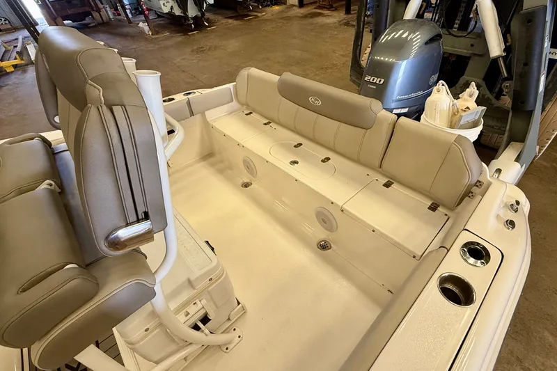 Slide: The Image of The image shows the cockpit of a 2023 Key West 219 FS boat with beige seating and an outboard motor. - 30