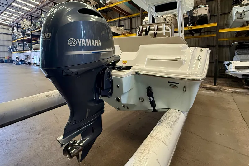Slide: The Image of A 2023 Key West 219 FS boat with a Yamaha outboard motor in a storage facility. - 4