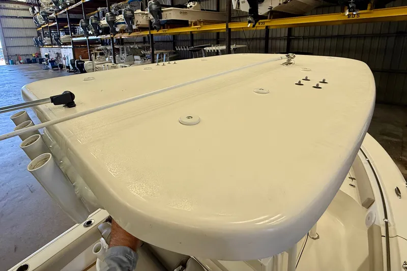 Slide: The Image of The image shows the deck of a Key West 219 FS boat in a storage facility. - 32