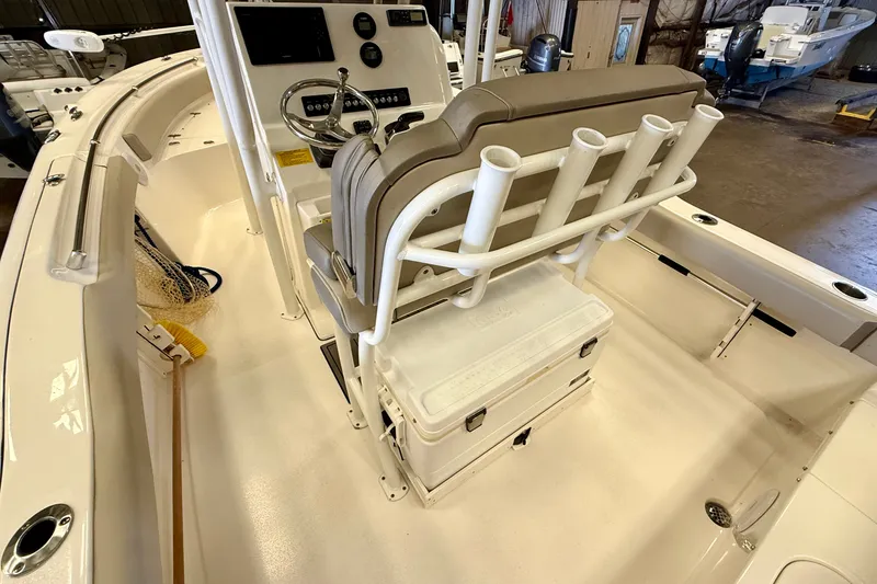Slide: The Image of The image shows the cockpit of a 2023 Key West 219 FS boat with a helm console and seating. - 26