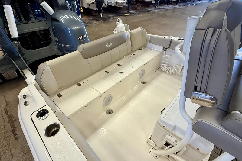Slide: The Image of The image shows the cockpit of a 2023 Key West 219 FS boat with beige seating. - 28