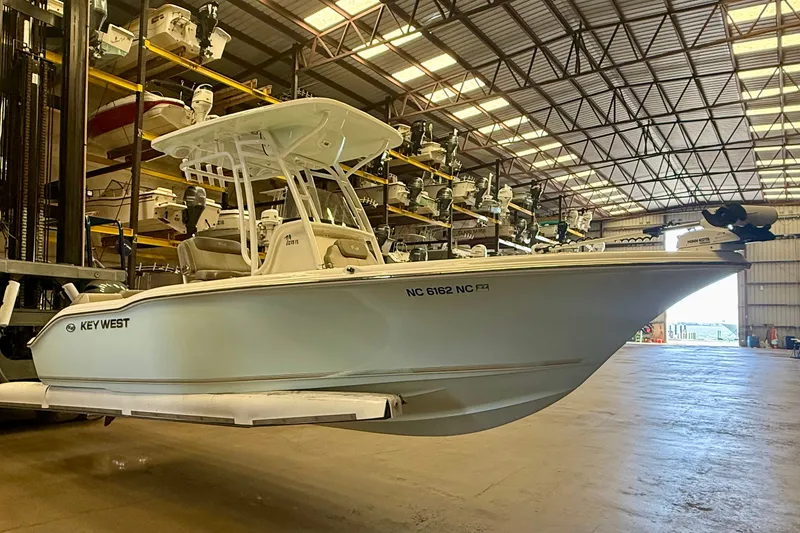 Slide: The Image of A 2023 Key West 219 FS boat is in a large warehouse. - 6