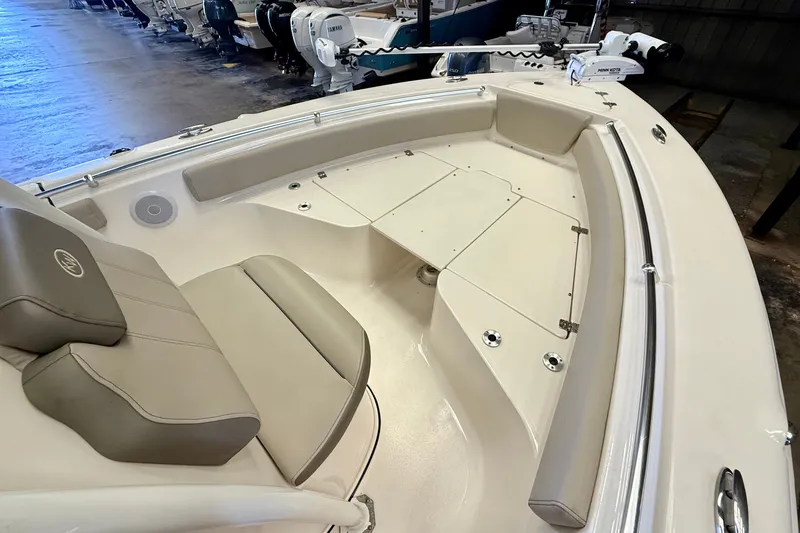 Slide: The Image of The image shows the bow of a 2023 Key West 219 FS boat with beige upholstery. - 12