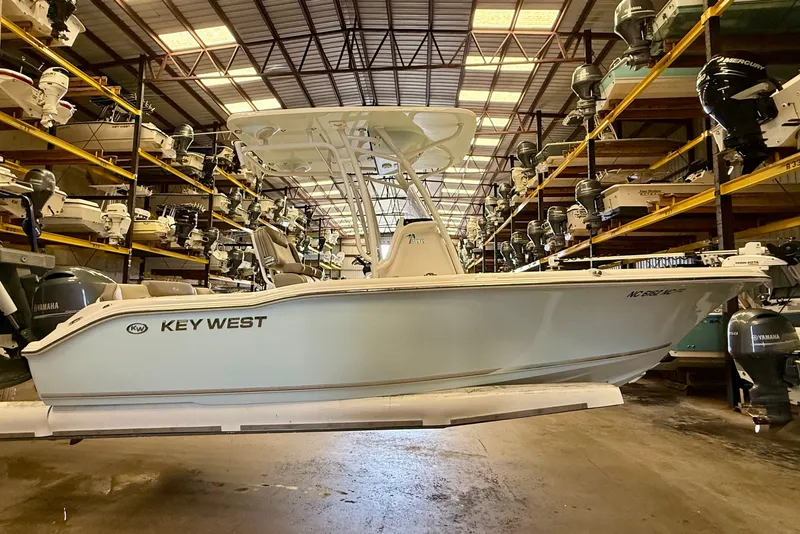 Slide: The Image of A 2023 Key West 219 FS boat in a warehouse, surrounded by other boats. - 8